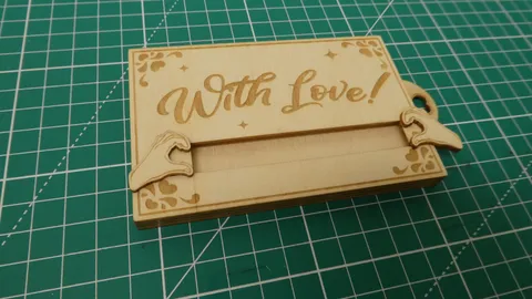 Laser engraved sliding wood gift card holder with heart hands design.