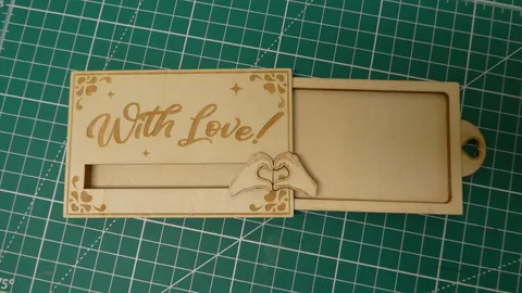 Laser engraved sliding wood gift card holder with heart hands design.