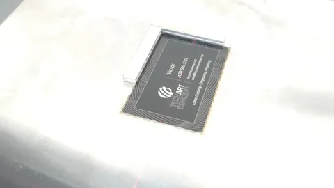 Custom fiber laser engraved black anodized aluminum business cards for TechArt Concept, showing high-precision marking of QR codes and detailed service lists on metal.