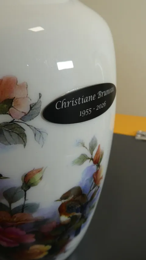 Laser engraved black aluminum memorial nameplate custom shaped on a white ceramic urn for Christiane Bruneau.