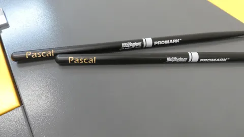 Custom laser etched black ProMark Mike Portnoy drumsticks featuring a precise name engraving.