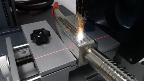 Fiber laser machine deep engraving a military retirement gift inscription onto a steel Halligan bar.